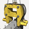 Retroescavadeira sobre pneus, equipada com arrasador hidráulico para muros